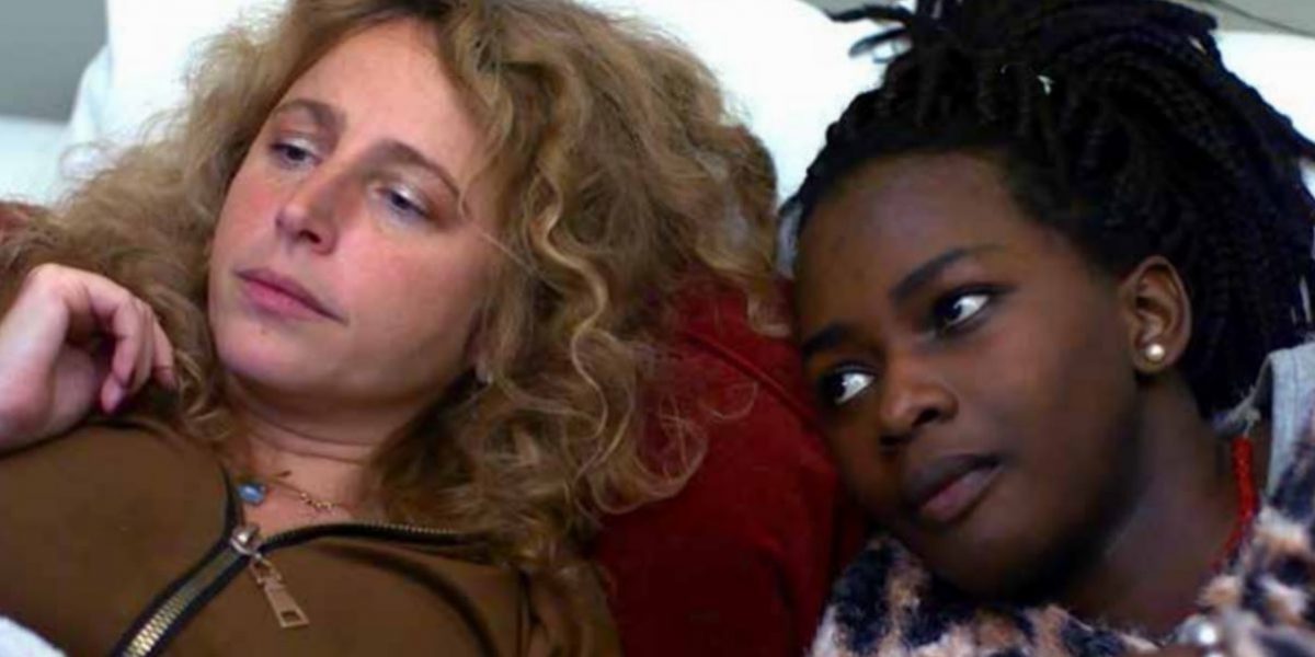 Brigitte from Brussels, left, and Flavia, right, a forced migrant from East Africa, watch Netflix together in Brigitte’s apartment.