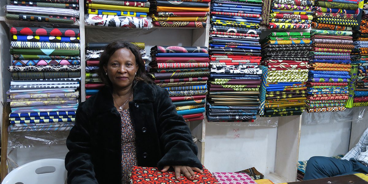 Janette sitting inside of her textile store in Uganda.