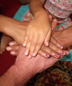 Hands of refugees and volunteers